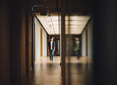 Man walking down a corridor.