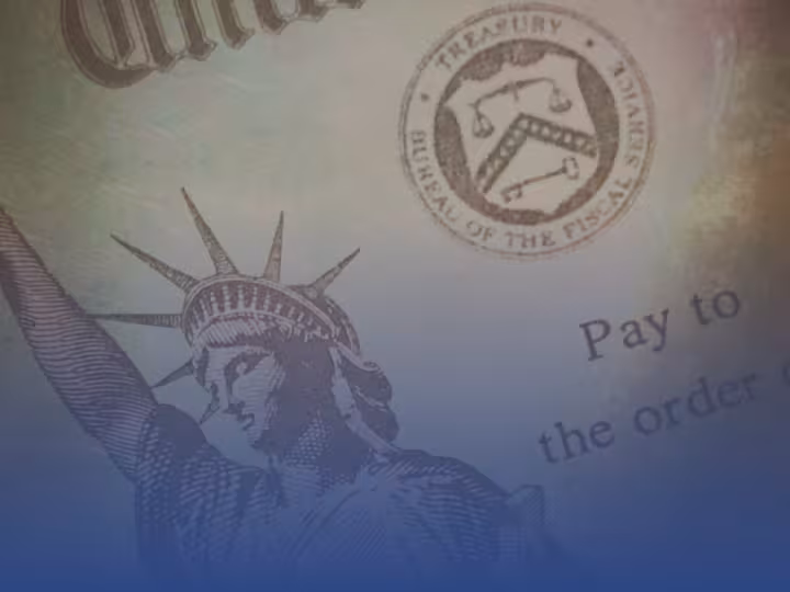 A close-up image of a U.S. Treasury check featuring the Statue of Liberty and the Treasury seal, tinted with blue shading.